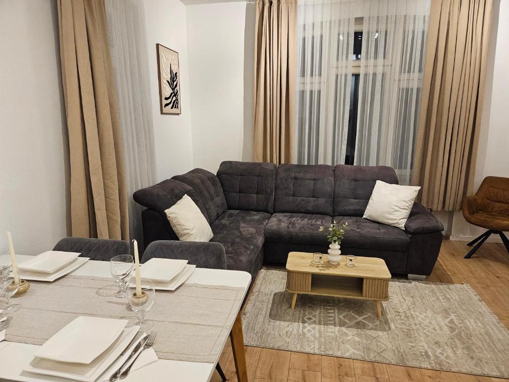 a living room with a couch and a table at Sero`s Apartment in Hahnstätten
