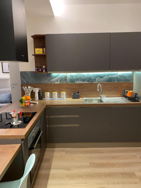 a kitchen with a sink and a counter top at Casa FATA MELANIA-free parking-self check in in Tavernerio