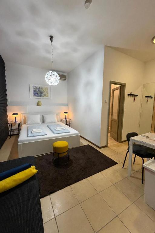a living room with a bed and a table at Panzió Apartments in Budapest