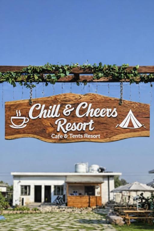 a wooden sign that reads chili and cheese resort cats and tents resort at Chill and Cheers Resort in Dehradun