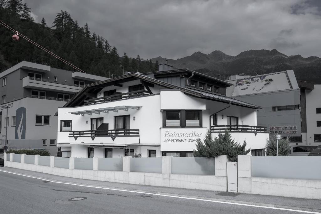 a large white building on the side of a street at Apart Reinstadler in Sölden