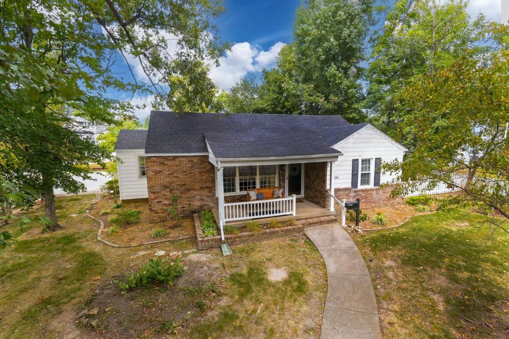 a home on a hill with a driveway at Walkable 2BR Cottage in Downtown Marion in Marion