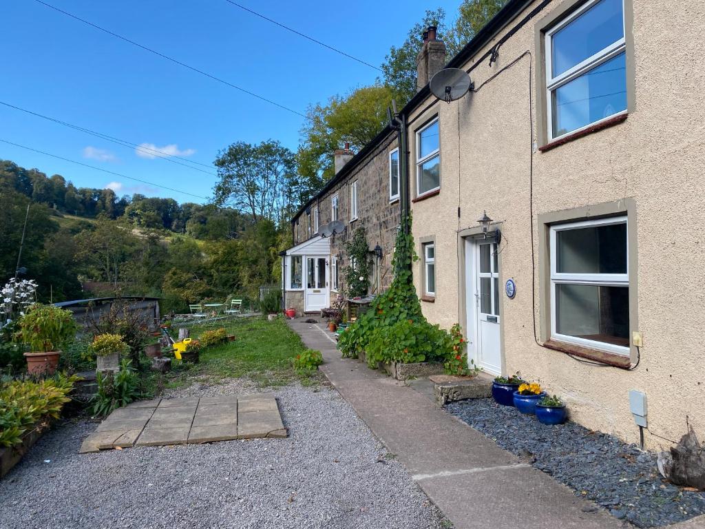 a house with a garden in front of it at Carmel Cottage - Forest of Dean in Lydbrook