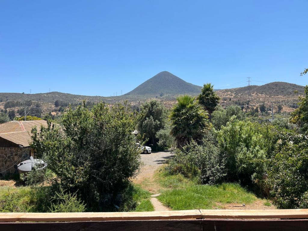a dirt road with a mountain in the background at Cabañas Sra Mery in Quilimarí