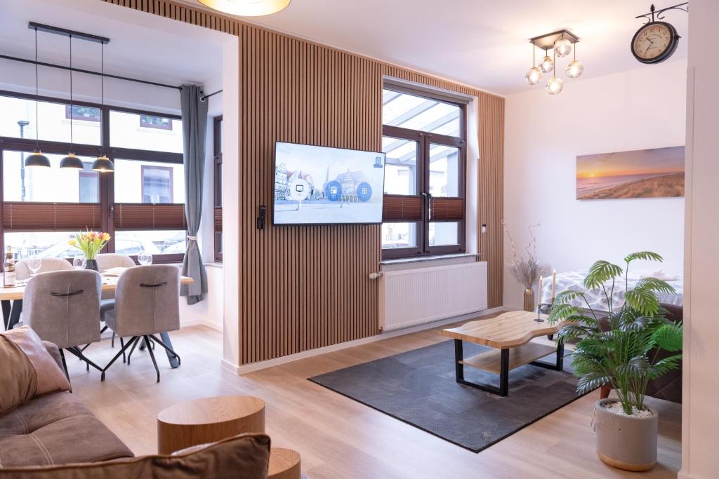 a living room with a couch and a table at Elite Weser Apartments in Bremen