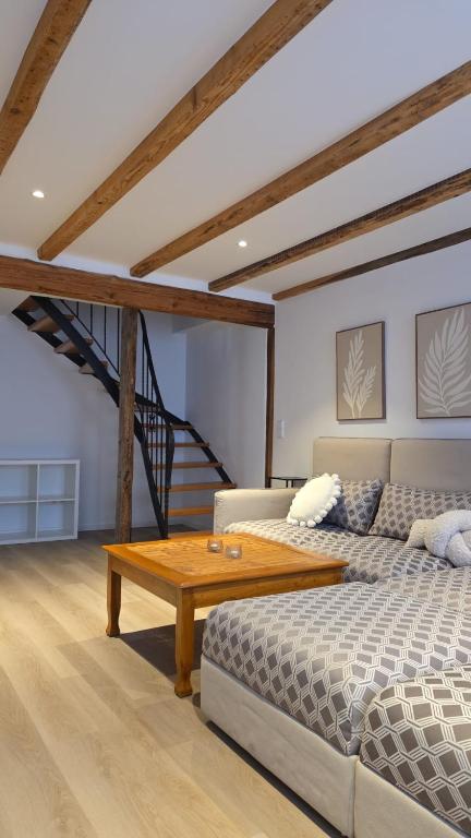 a living room with a bed and a coffee table at Hof Busen Malibu in Mönchengladbach