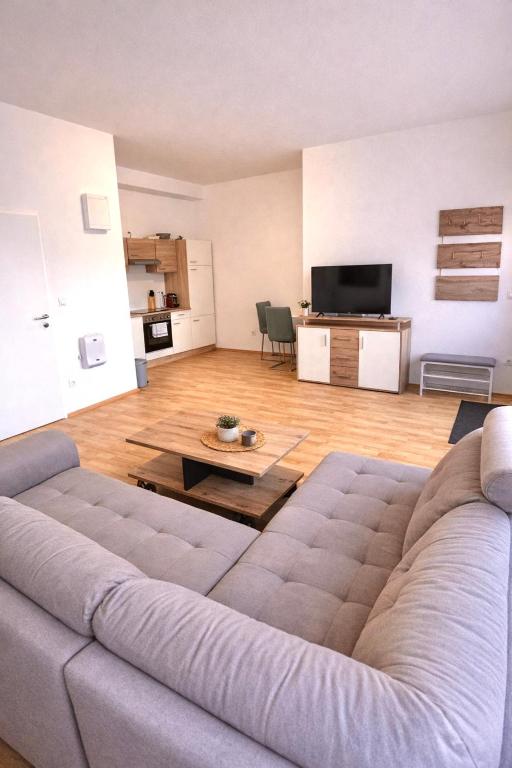 a living room with a couch and a table at Rohrbach Apartments in Ternitz