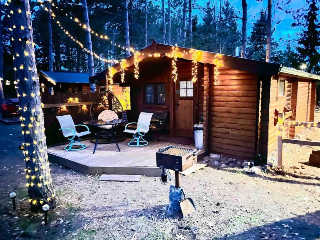a cabin with a table and chairs and lights at Lakeshore Lily Pad in Hayward