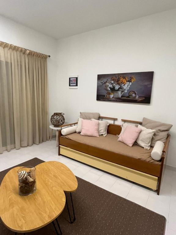 a living room with a couch and a table at Jimilio 1 in Spata