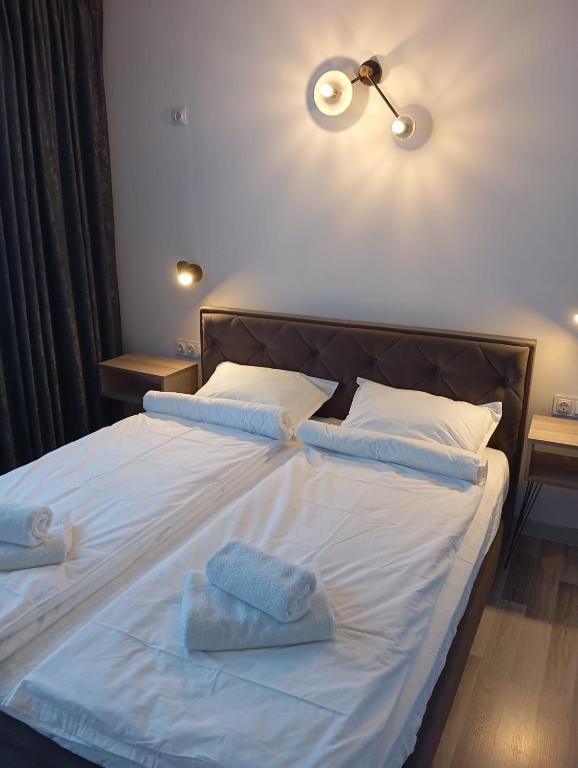 a bedroom with a bed with two towels on it at Monfort Studio in Bansko