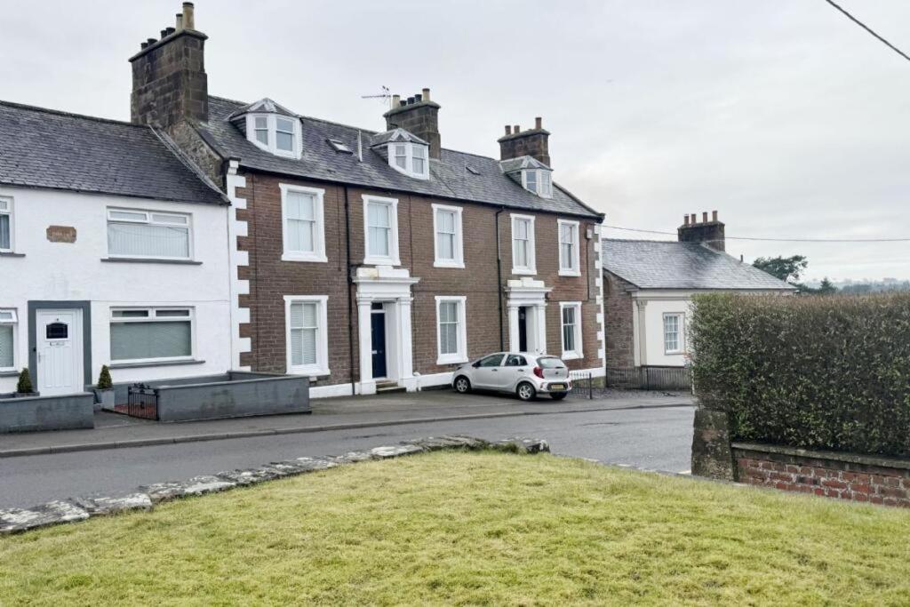 a house with a car parked in front of it at Lochmaben in Lochmaben