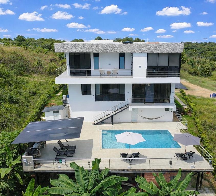 an aerial view of a house with a swimming pool at Arrayanes 33, Ricaurte San Marcos in Ricaurte