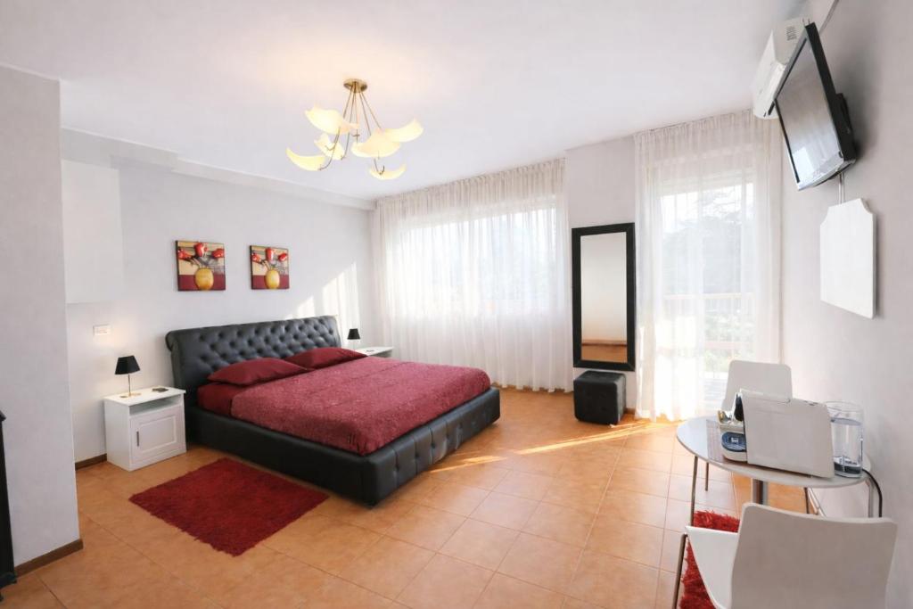 a bedroom with a bed and a television in it at Assago Forum Apartment - MilanoFiori in Assago