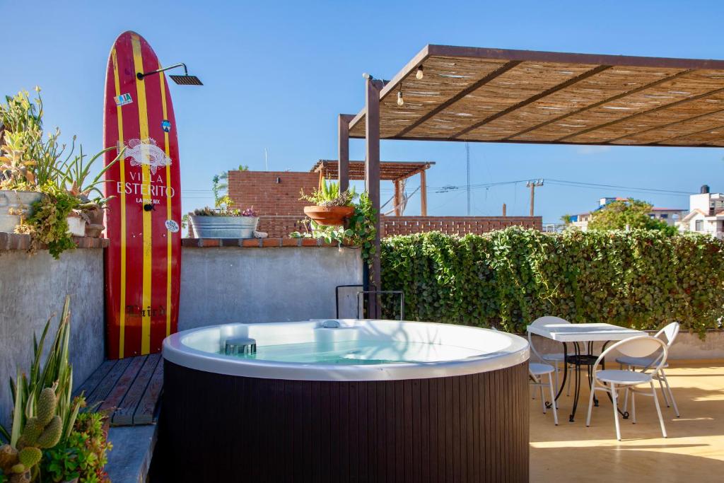 a hot tub on a patio with a surfboard at Villa Esterito - La Paz Baja California Sur in La Paz