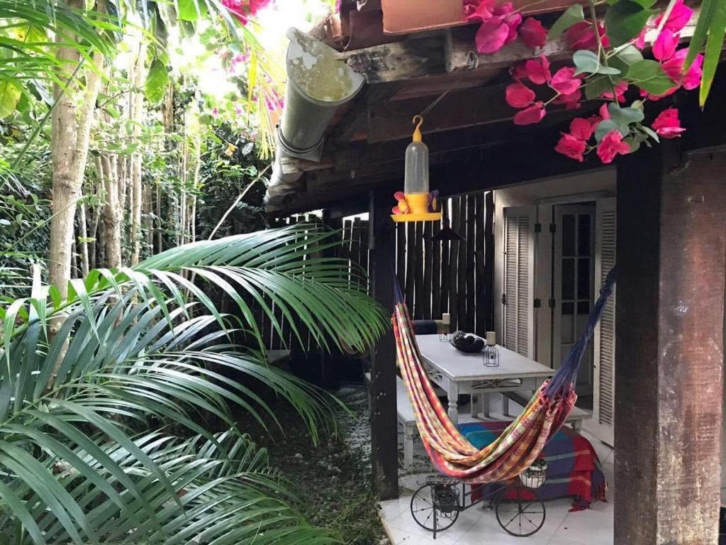a pair of hammocks on the side of a house at Casa Praiana Búzios in Búzios