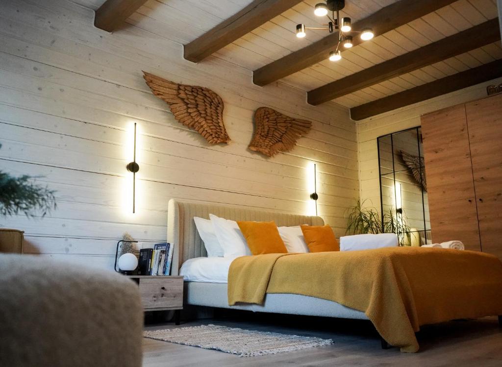 a bedroom with a bed with orange pillows at Котедж Rest Hill in Vorokhta
