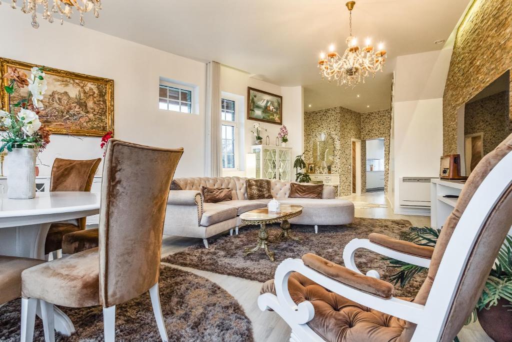 a living room filled with furniture and a chandelier at Cidadela do Viriato Deluxe in Viseu