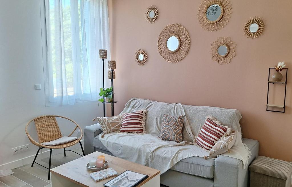 a living room with a couch and mirrors on the wall at La Valiette in La Seyne-sur-Mer