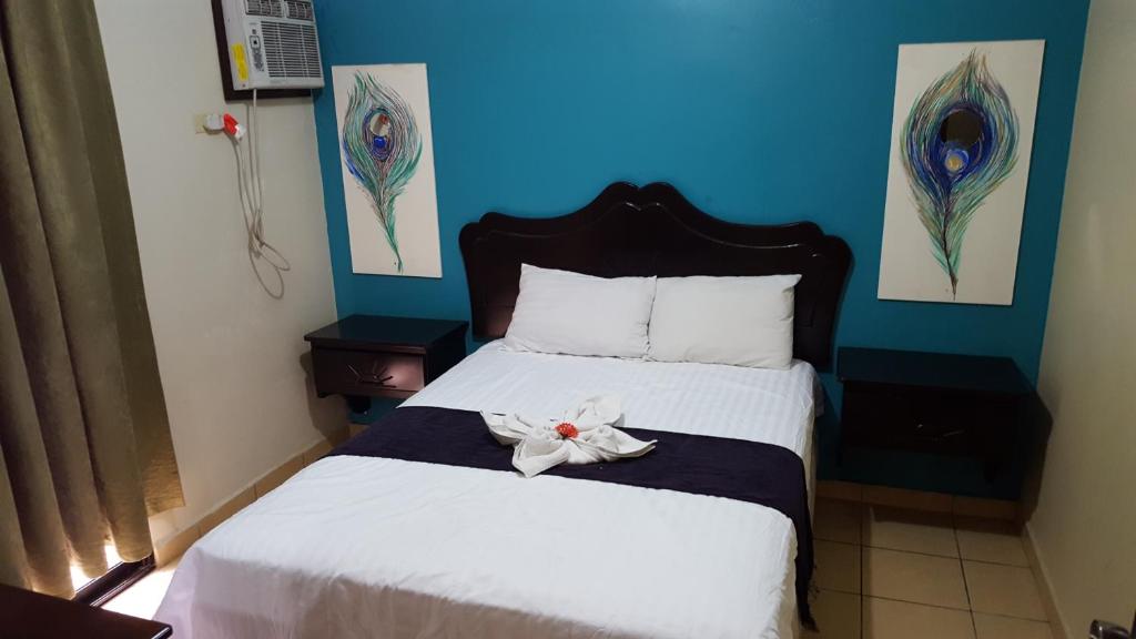 מיטה או מיטות בחדר ב-Apart Hotel Pico Bonito