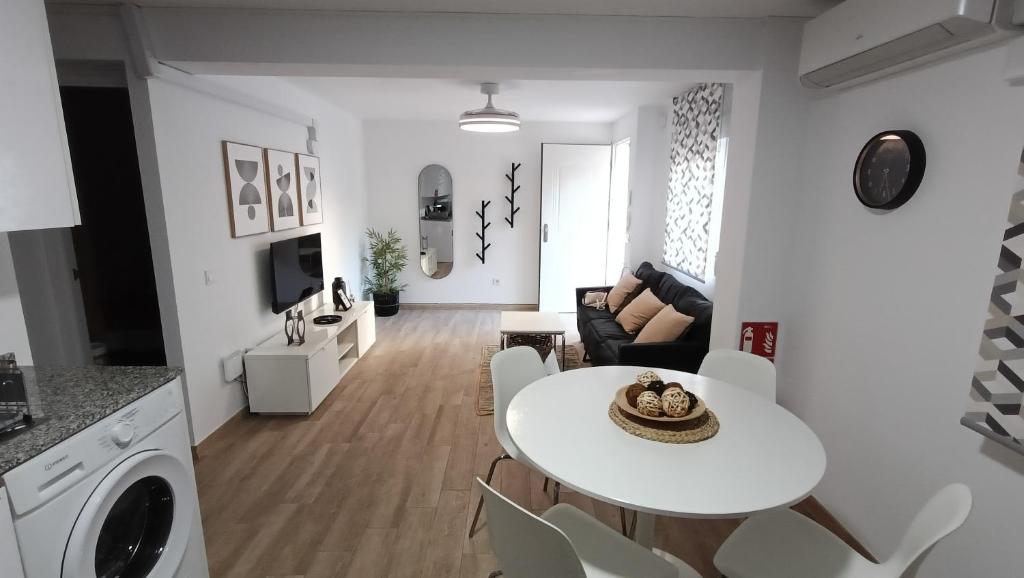 a white living room with a white table and chairs at Los Naranjos de Marbella in Marbella