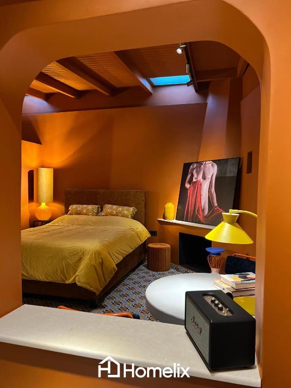 a bedroom with a bed and a table with a lamp at Santa Clara - the revolution of living in Chalkida
