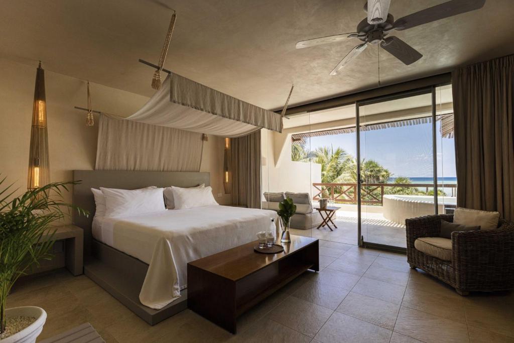 a bedroom with a bed and a view of the ocean at Azure Horizon Suite in Balcheil