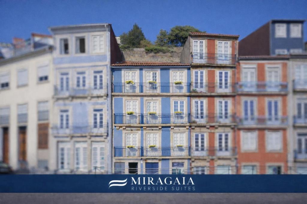 a tall building with balconies on the side of it at Miragaia - Riverside Suites - Adults Only in Porto