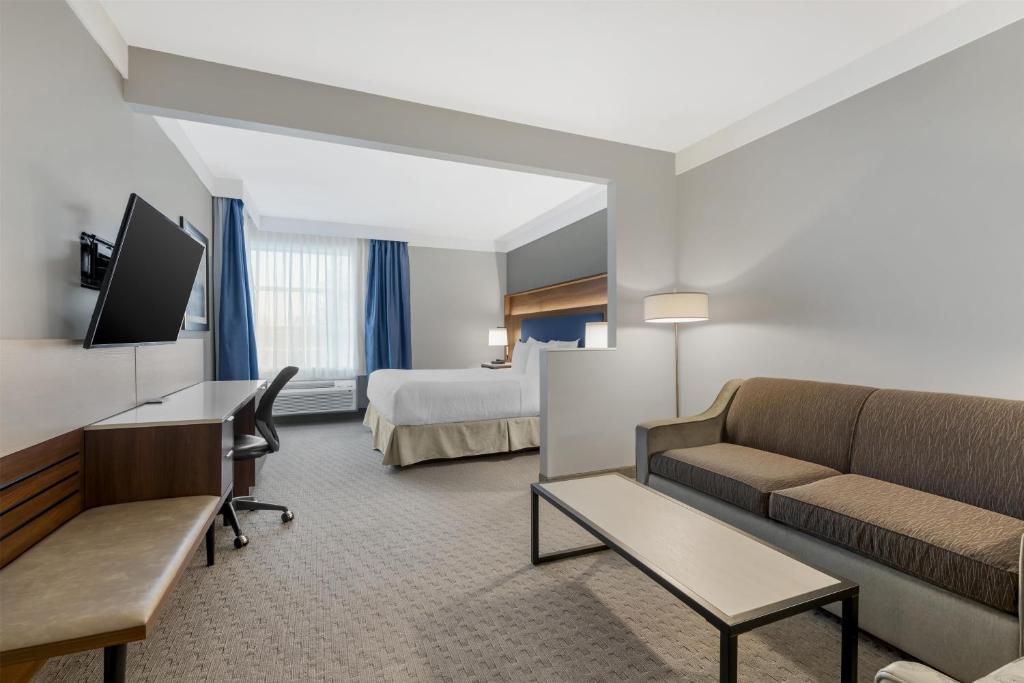 a hotel room with a couch and a bed at Best Western Plus Revelstoke in Revelstoke