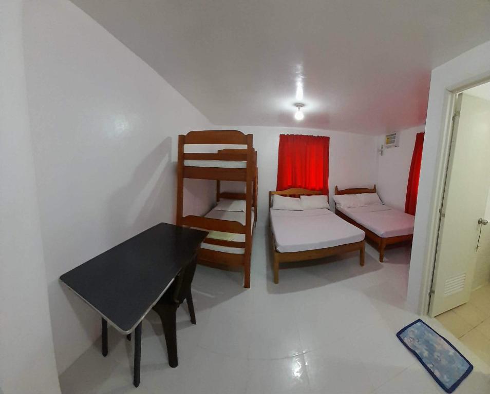 a room with a bed and a table and a chair at Dandal Bay view in El Nido