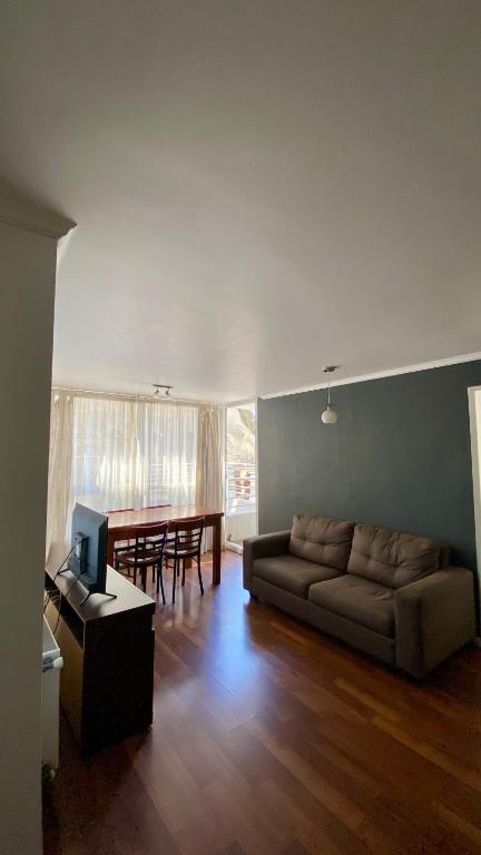 a living room with a couch and a table at Borde Costero in Valparaíso