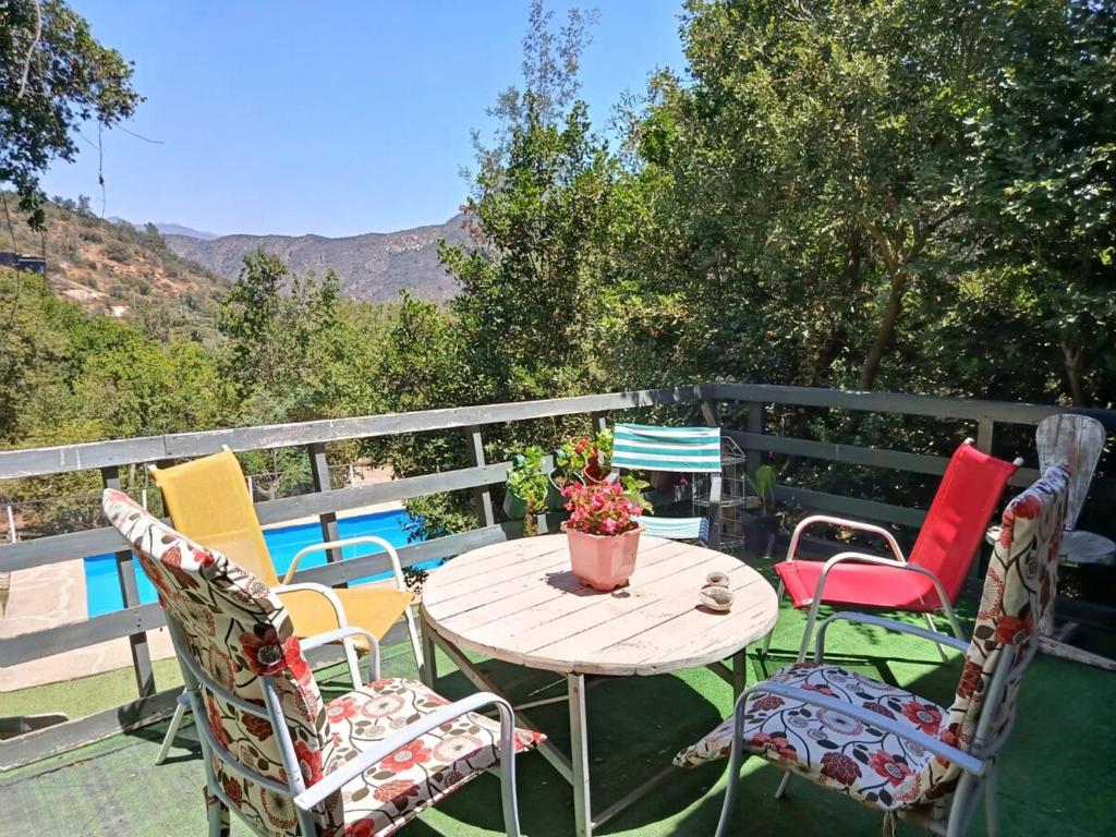 a table and chairs on a patio with a view at Casa Olmué in Olmué
