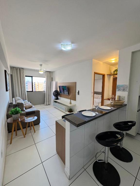 a large living room with a kitchen and a living room at Lindo APTO na Ponta Verde in Maceió