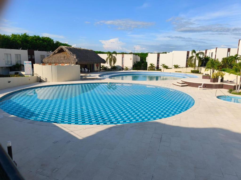 a large swimming pool with blue tiles on the ground at Casa de Verano Málaga Confort Sol y Piscina in Ricaurte