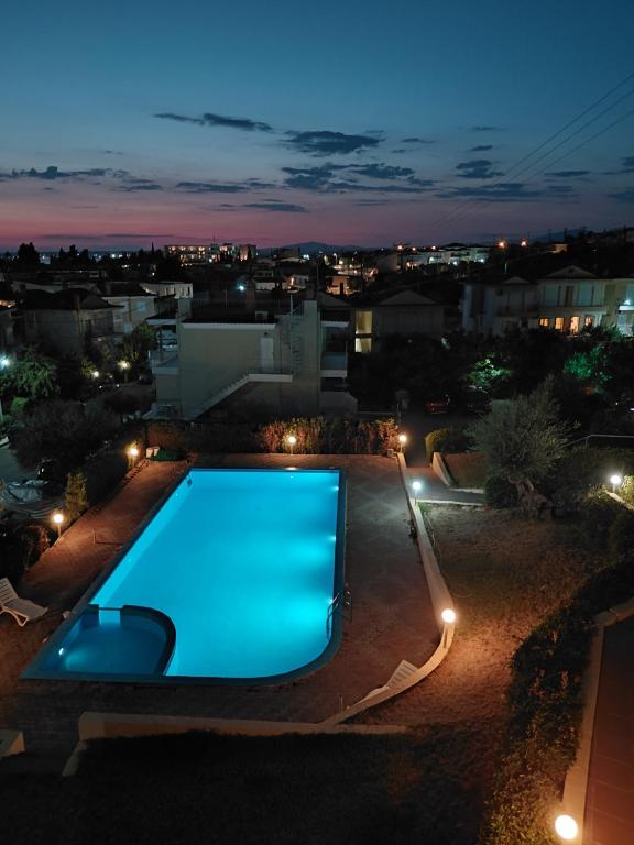 a swimming pool in a backyard at night at Gerakini 2BR Apt with Shared Pool in Gerakini