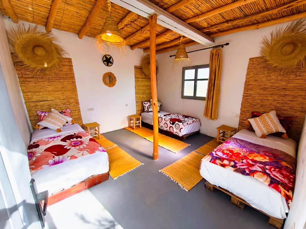a bedroom with two beds in a room at SURF TRIP ROOM IN OUASSANe in Essaouira