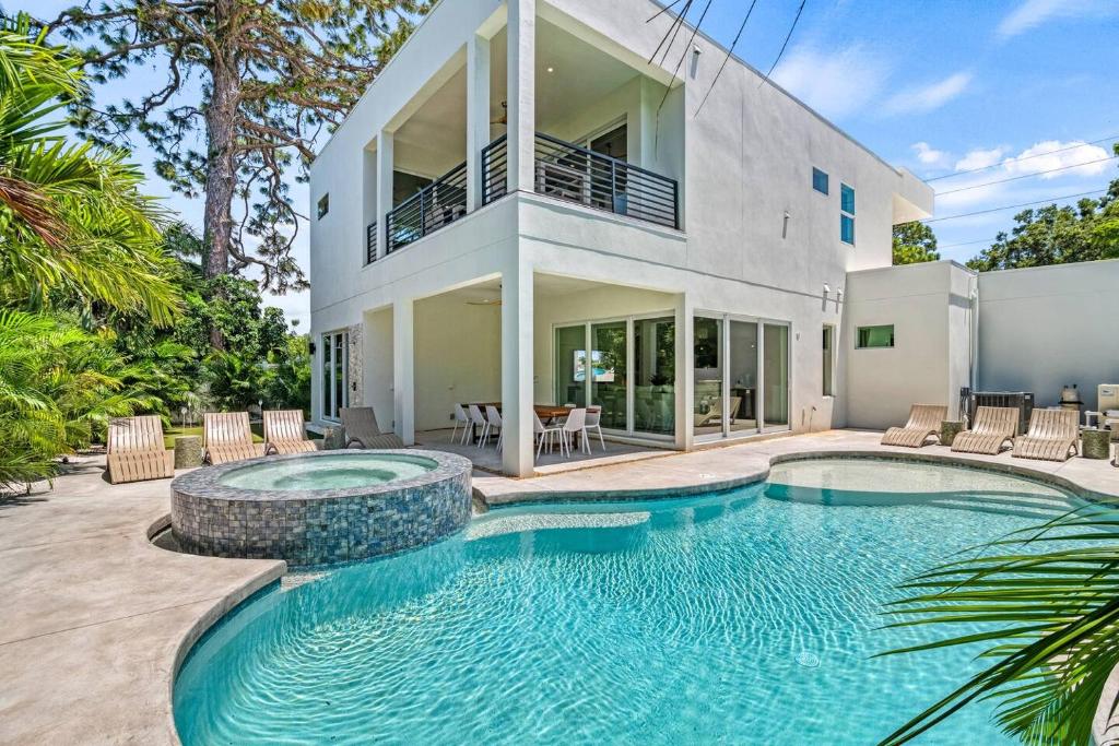 a swimming pool in front of a house at Waldemere's Wonderland in Sarasota