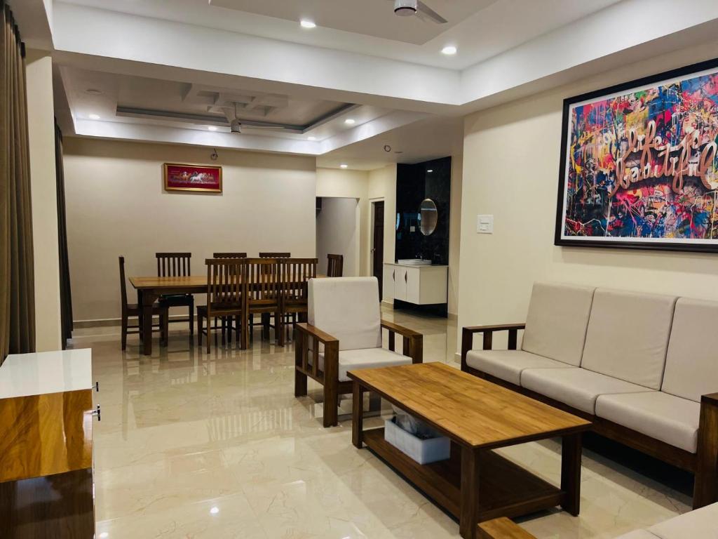a living room with a couch and a table at 3BHK Villa 15 min Thommankuthu Falls Groups in Thodupuzha