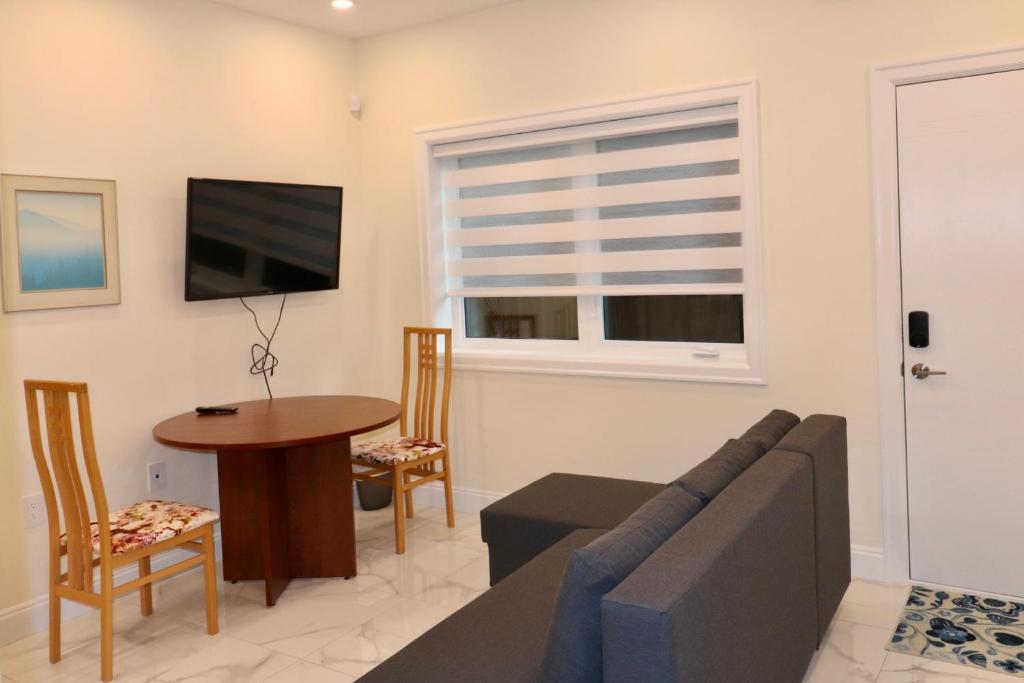 a living room with a couch and a table at SixPine - One bedroom suite in Vancouver