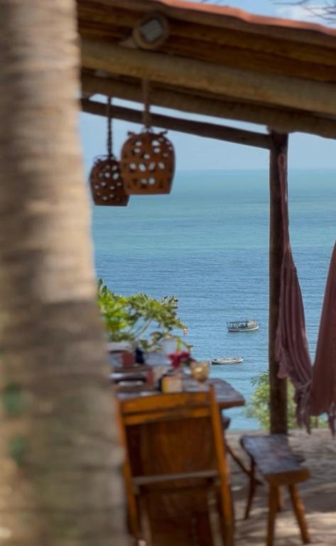 a view of the ocean from the porch of a house at Pousada Vila Matury in Icapuí
