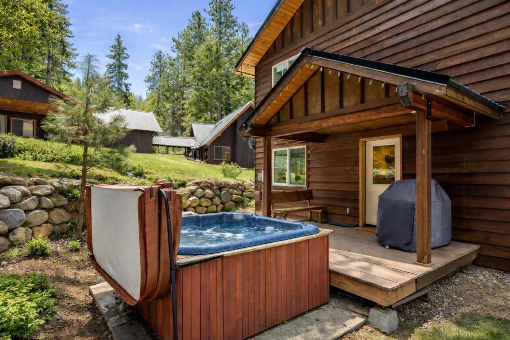 a hot tub on a deck next to a house at Just Plain Getaway in Leavenworth