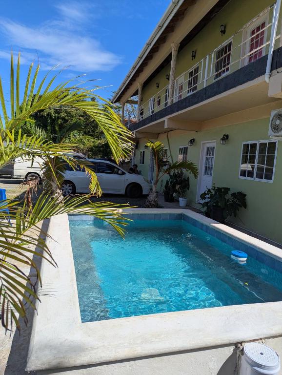 a swimming pool in front of a house at Jacqueline's Court in Mount Pleasant