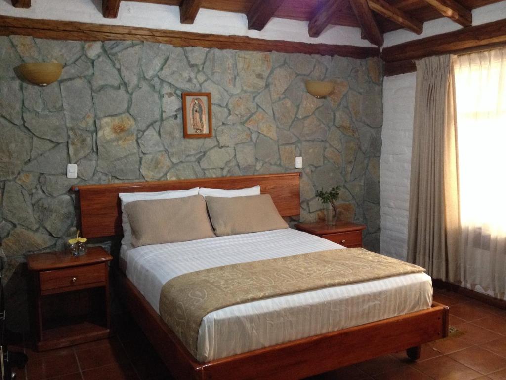 Postel nebo postele na pokoji v ubytování Hotel y Hosteria Natabuela