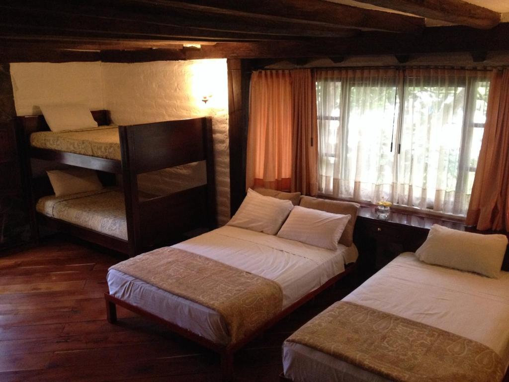 Postel nebo postele na pokoji v ubytování Hotel y Hosteria Natabuela