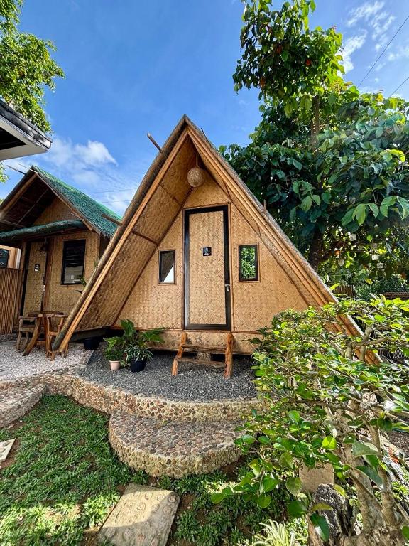 a small house with a thatched roof at Nipa Hut Lodging House in Coron