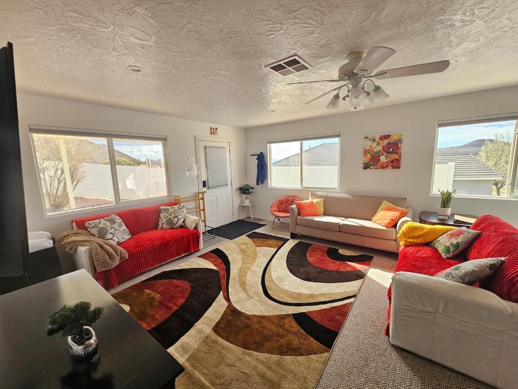 a living room with red couches and a rug at Mountain View near Zion in Hurricane
