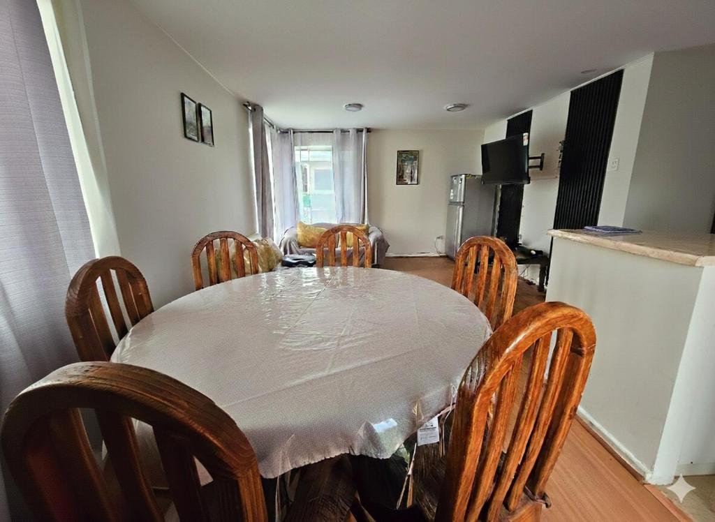a dining room with a table and chairs and a kitchen at Algarrobo, house in a condominium in Algarrobo