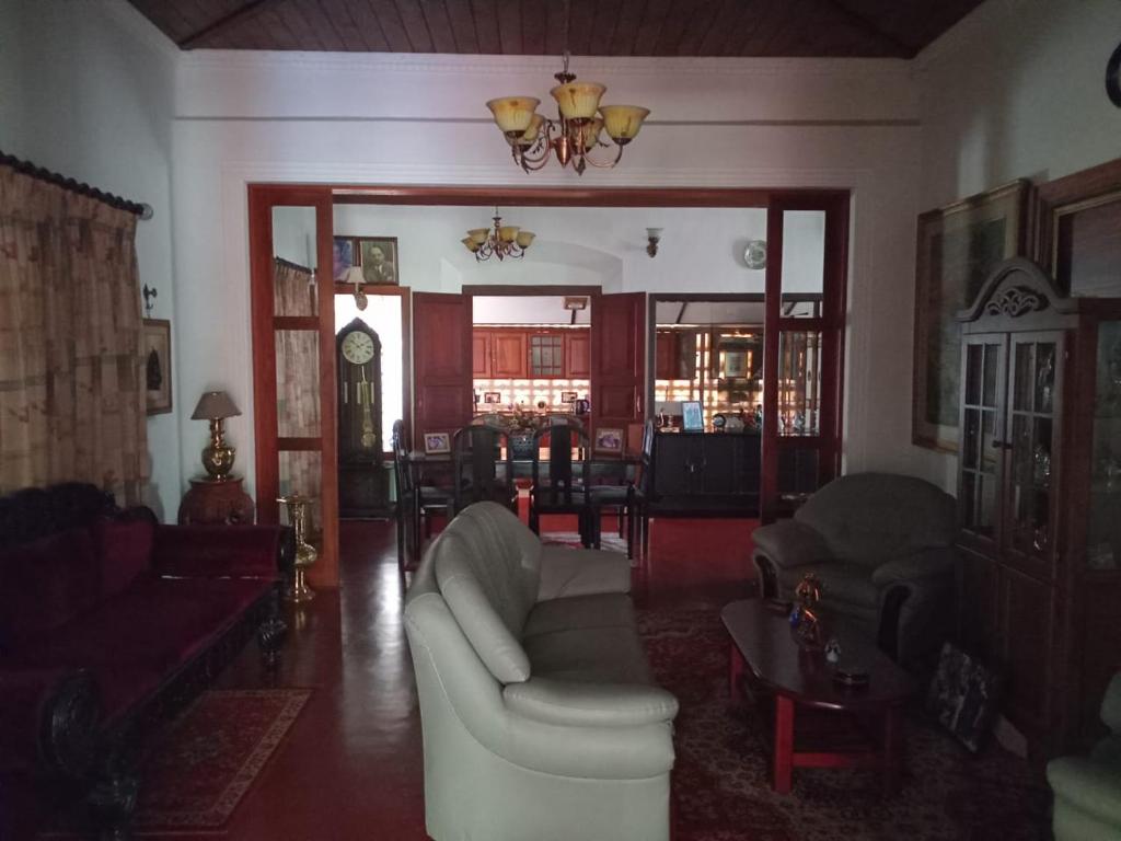 a living room with a couch and a table at The Garden Villa in Matara