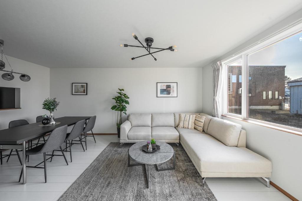 a living room with a couch and a table at Hills Niseko C in Niseko