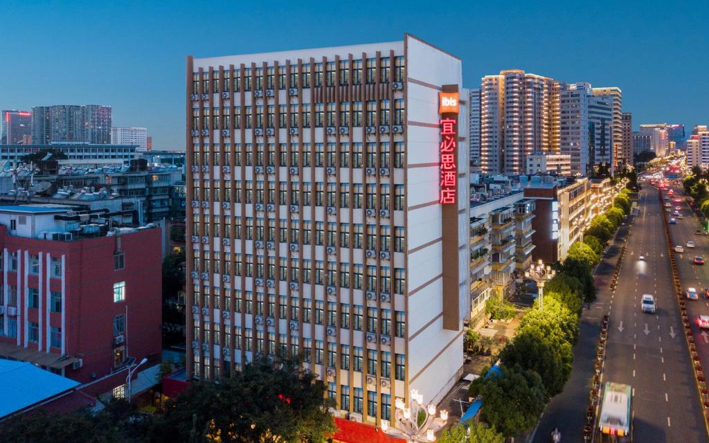 a rendering of a tall building in a city at 宜必思昆明火车站酒店Ibis Kunming Railway Station in Kunming