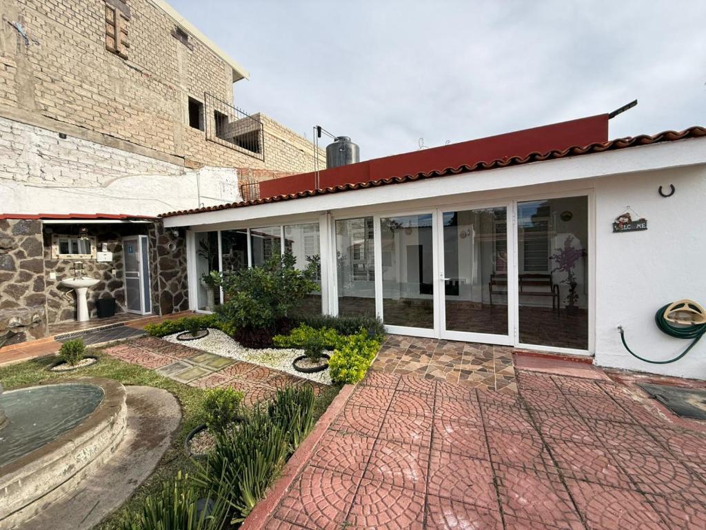 a house with a brick walkway in front of it at Serenity House Casa Huaxtla del Arenal in Huastla